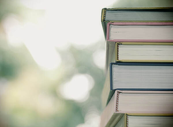 A stack of books against soft green light